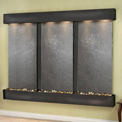 Wall-mounted water feature with three stone panels on a green wall.